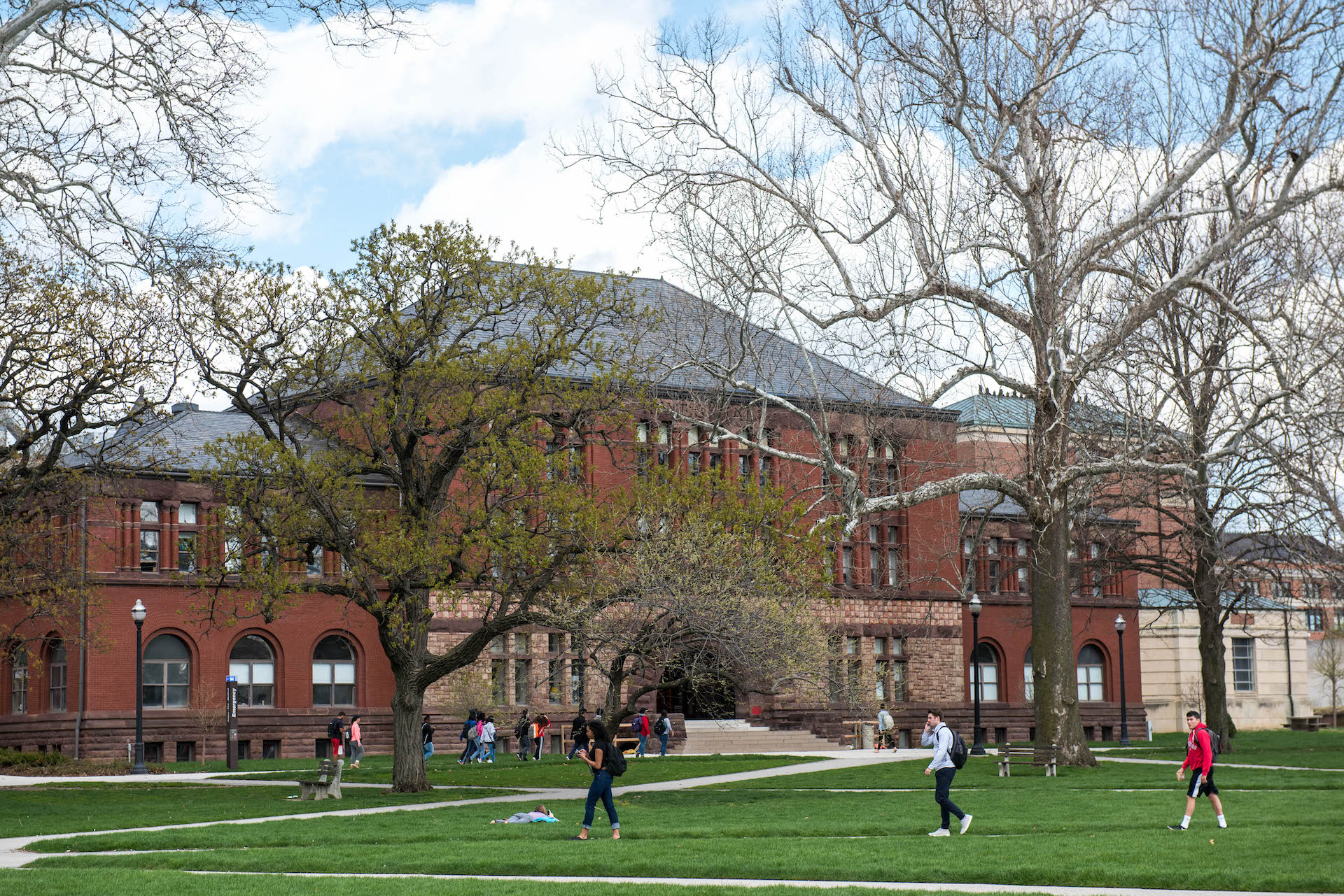 Students walk on the Ohio State campus, with Hayes Hall in the background.