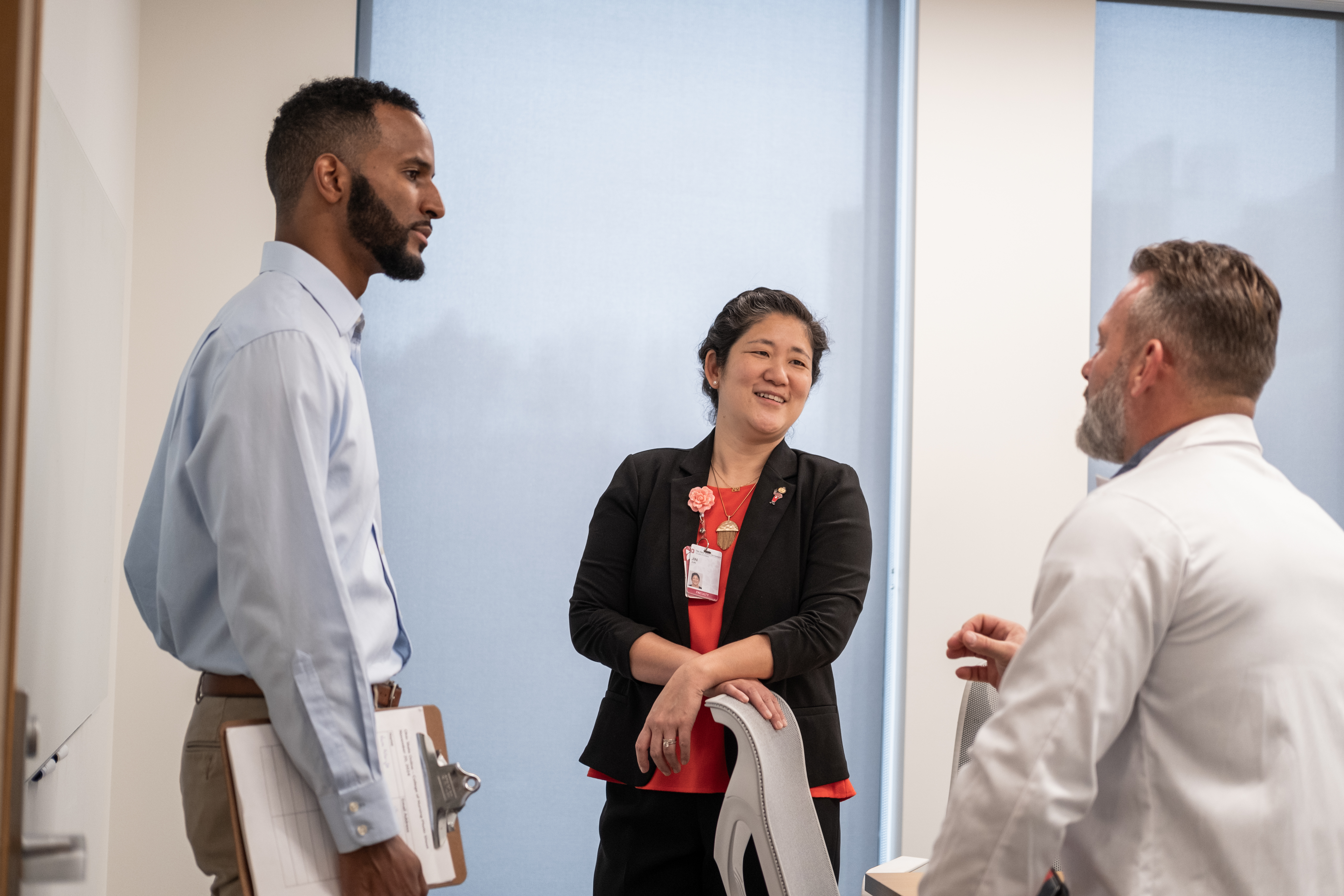 Three people circle up having a conversation