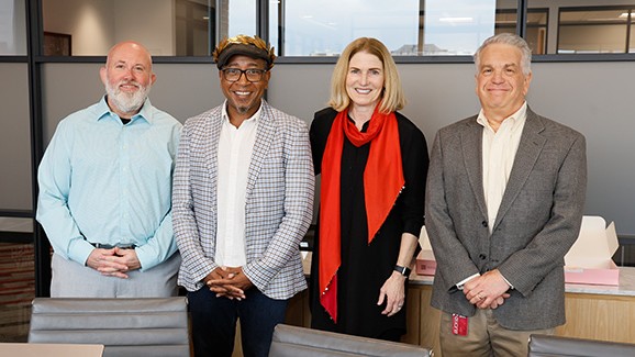 Charles Anderson stands with university leadership
