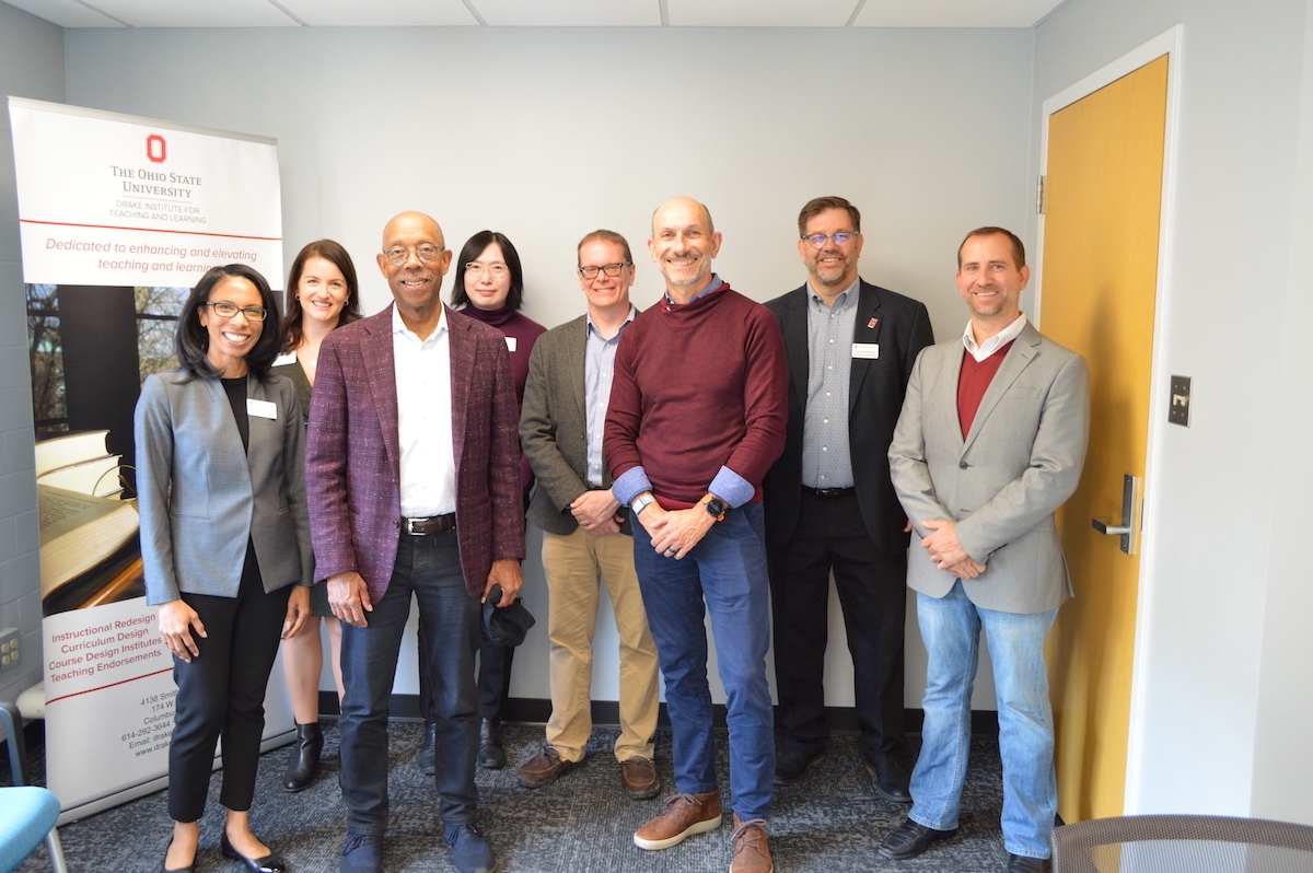 Drake Institute staff members pose with Dr. Michael V. Drake during an Autumn 2023 visit to the institute.