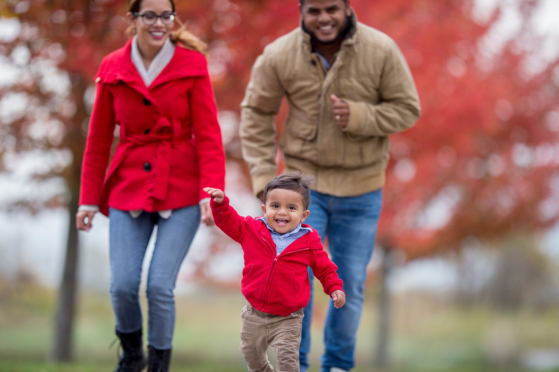 Two adults and a children enjoy a stroll through campus