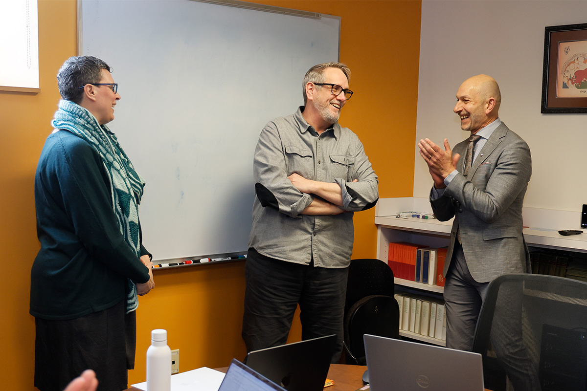 John Davidson smiles with academic leaders.