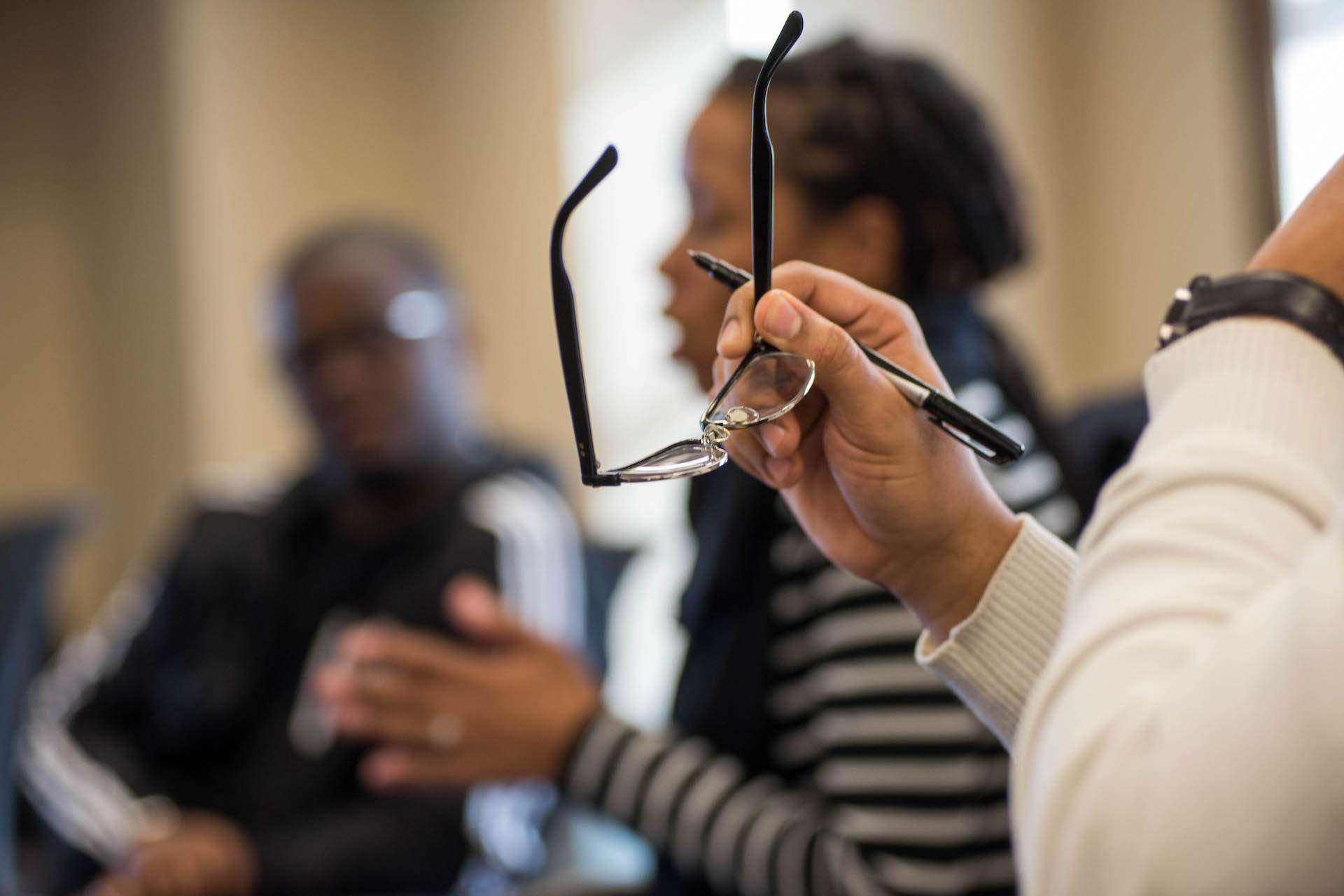 Picture of a classroom conversation exercise shows one black woman talking while others look on.