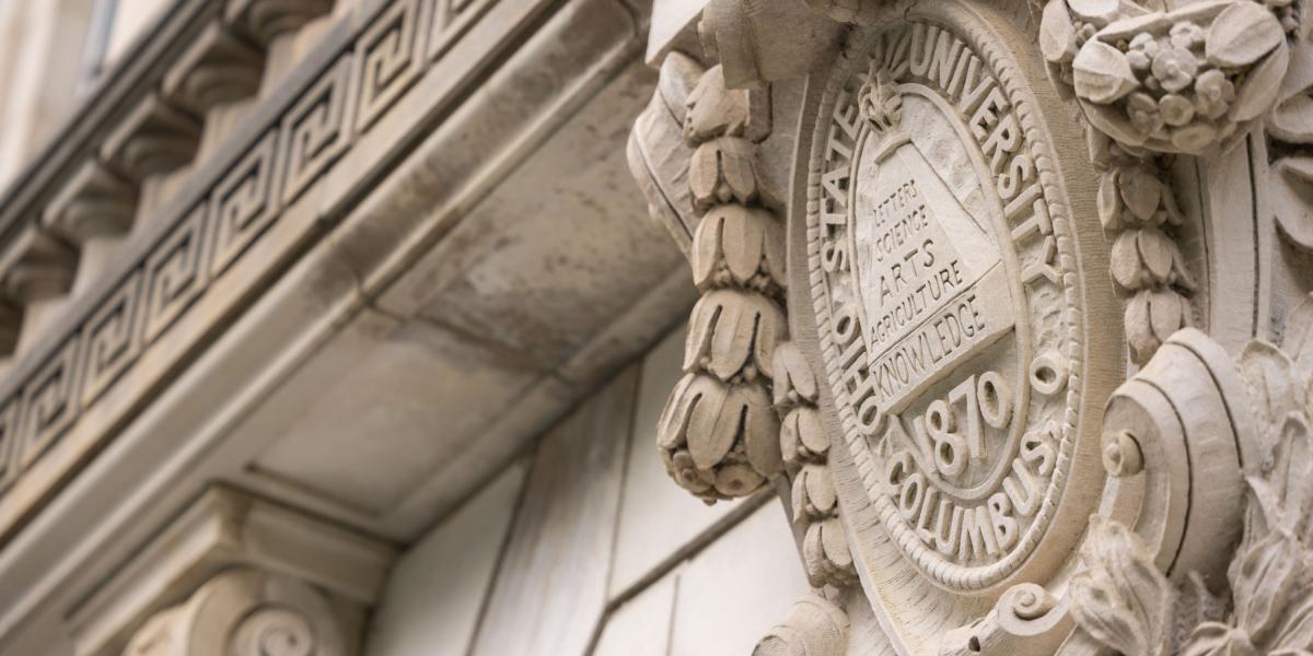 Close up of the university seal on a building