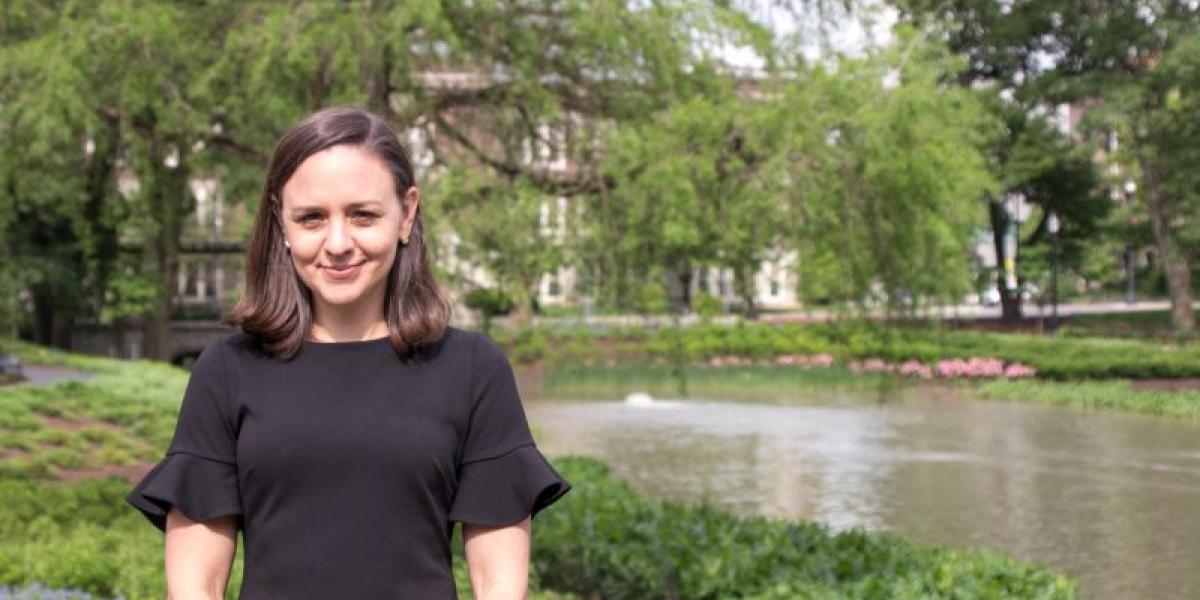 Patti Zettler standing in front of Mirror Lake on the Ohio State campus.