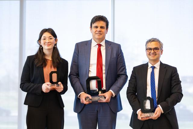 Three people with awards