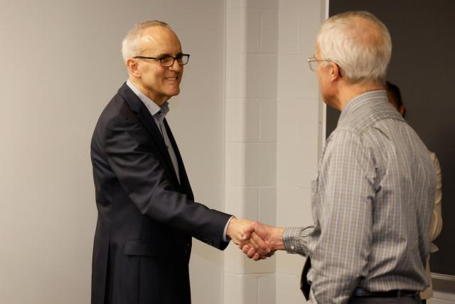 Dean Horn shakes Peter Hahn's hand.