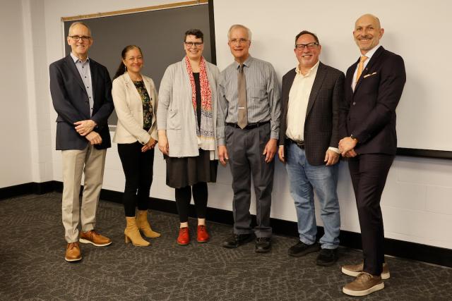 Five university leaders stand with Peter Hahn during his surprise announcement.