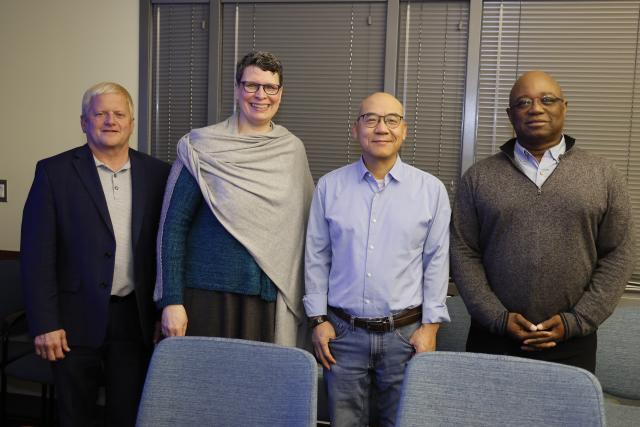 Shan-Lu Liu stands next to three academic leaders