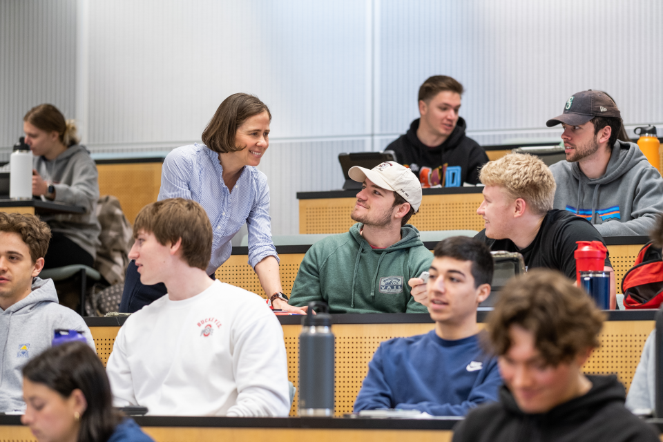 Faculty members interacting with students.